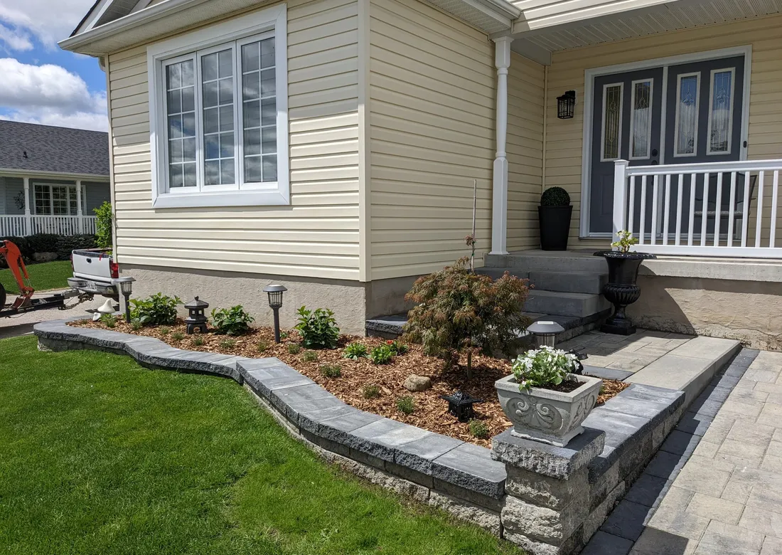 A beautiful front entrance with a newly installed garden wall, driveway extension. There are 2 landing and 3 steps