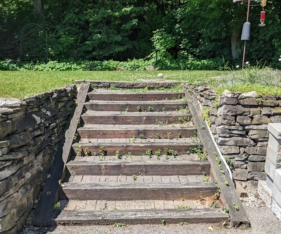 A 9 step-system from a ground-level to the top of a retaining wall