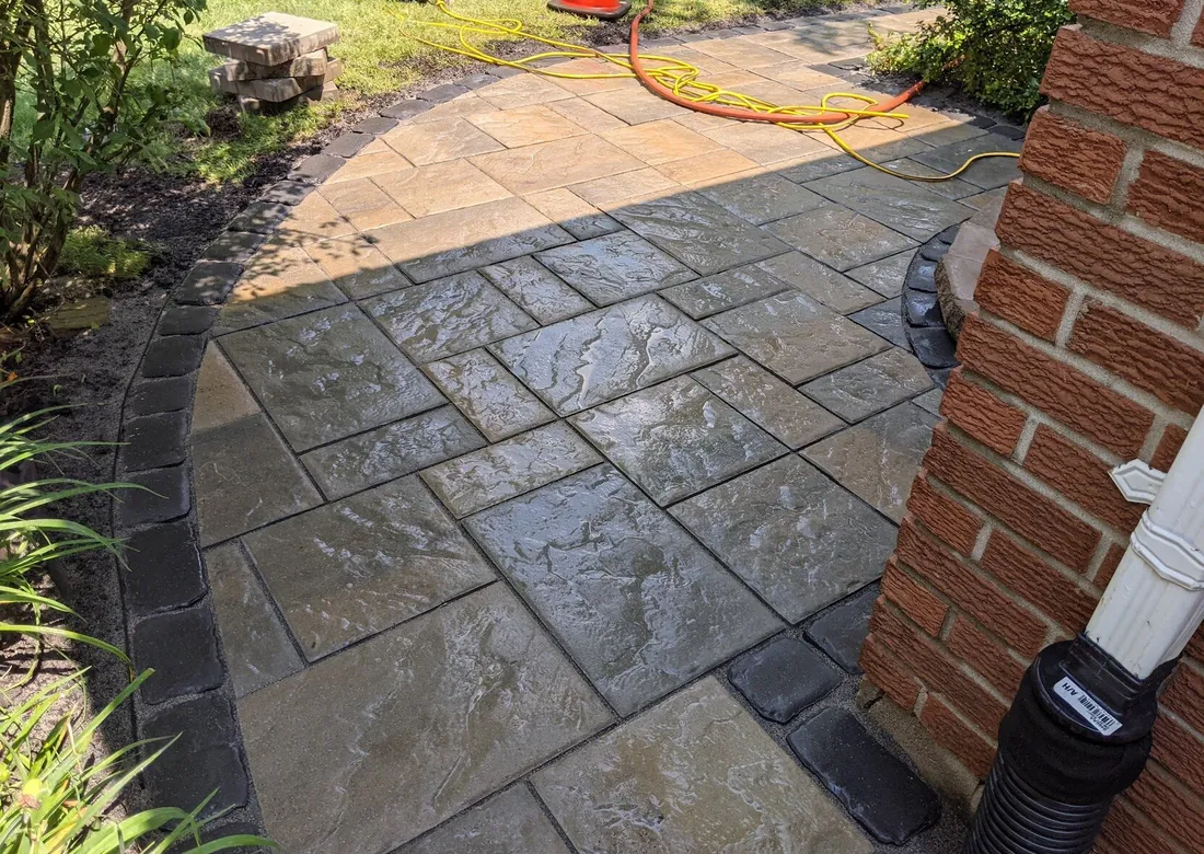 A front yard interlock landing with a curve