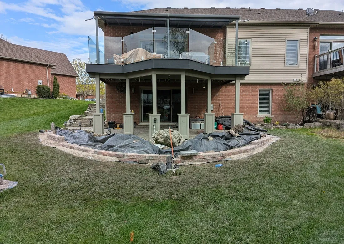 A wall system under installation, with 1-2 rows being present, and a clear drainage system in the front
