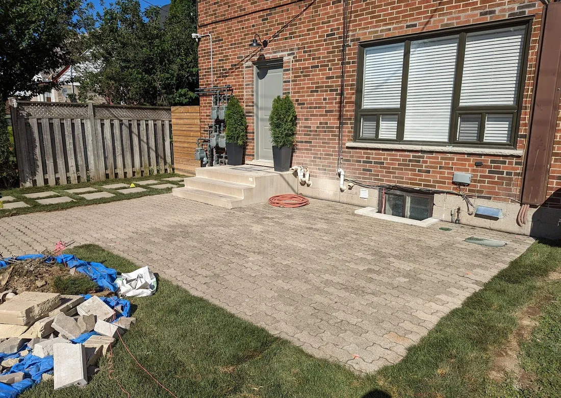 A front yard interlock landing with a curve