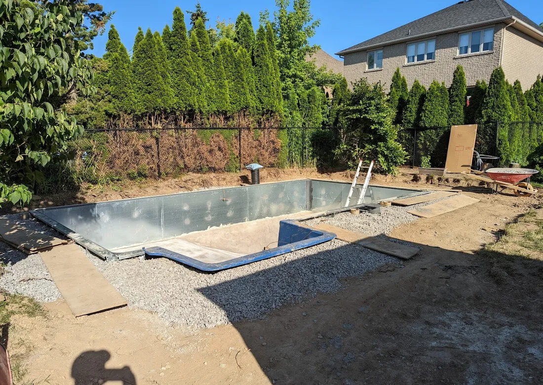 Pool structure installed, buried in gravel then eventually dirt 