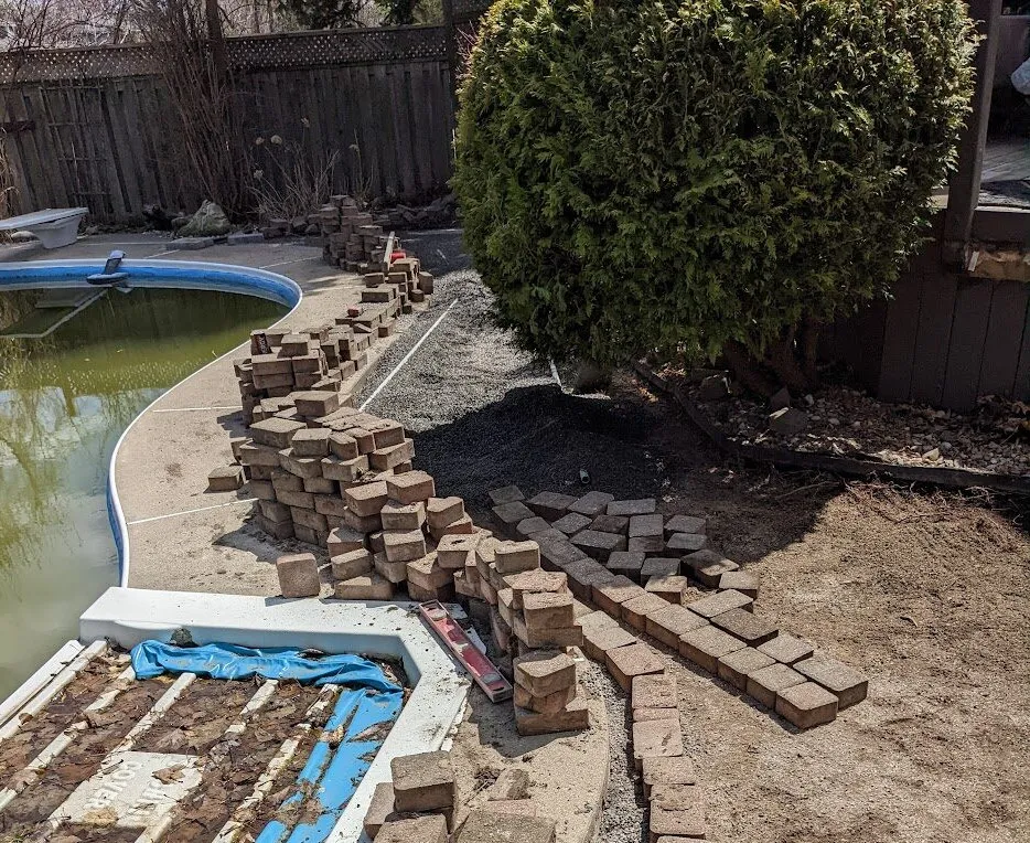 Paver area opened for base correction and repair work.