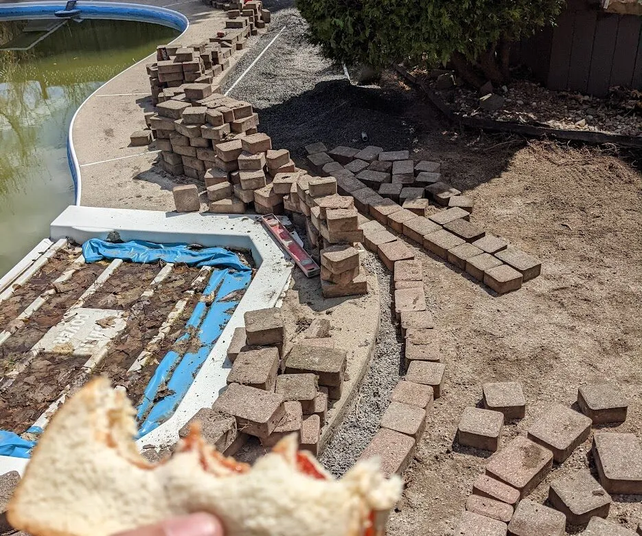 Deconstruction of small pavers from a pool